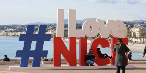 Nice, France - January 29, 2019: Large Letters With Hashtag Sign I LOVE NICE, Logo Symbol On Mediterranean Sea View And Cityscape Of Nice City, French Riviera, France, Europe